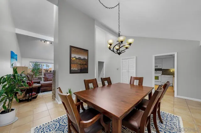 a view of a dining room with furniture and chandelier