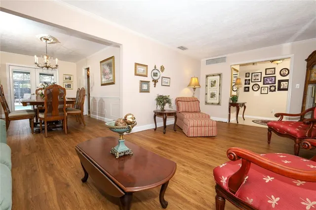 a living room with fireplace furniture and wooden floor