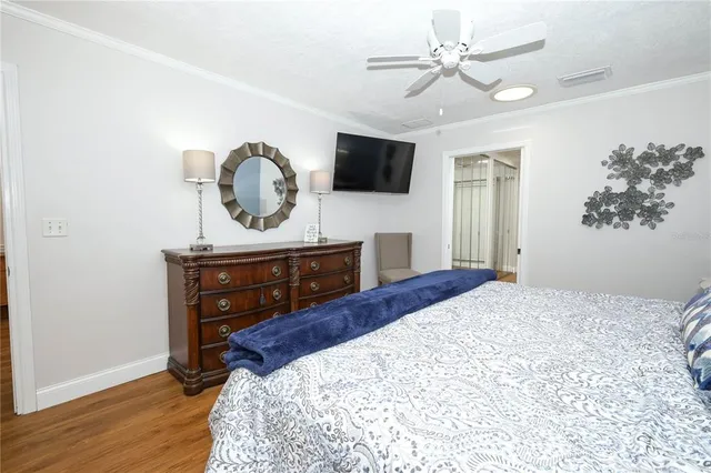 a bedroom with a bed and a television