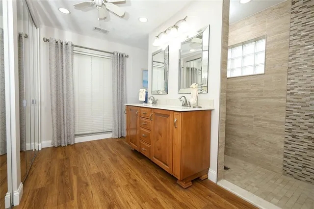 a bathroom with a sink a mirror and shower