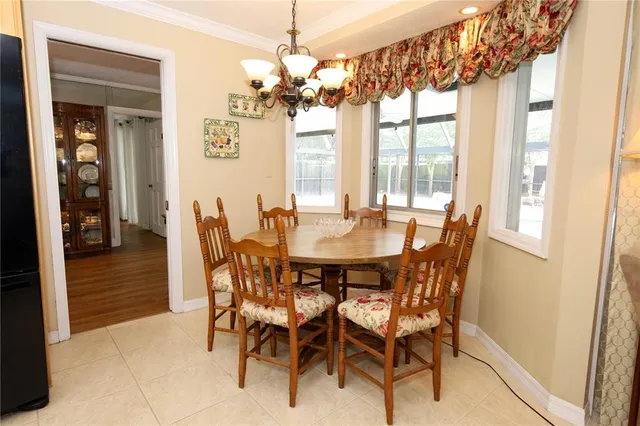 a view of a dining room with furniture wooden floor and chandelier