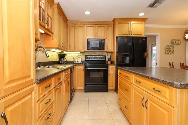 a kitchen with stainless steel appliances granite countertop a stove and a refrigerator