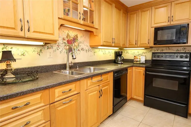 a kitchen with stainless steel appliances granite countertop a sink stove and microwave