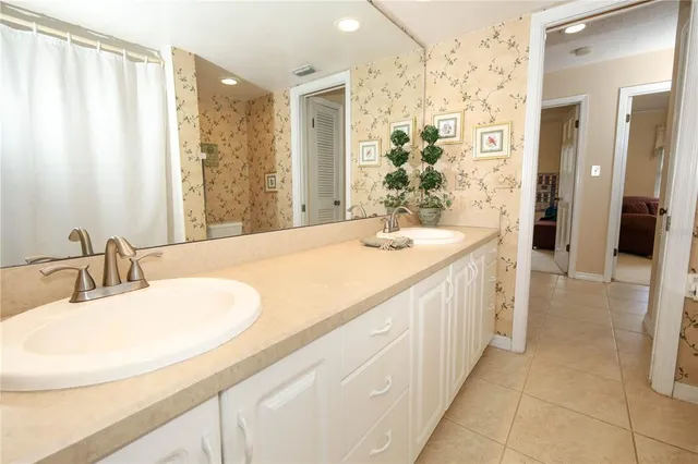a bathroom with a double vanity sink and a mirror