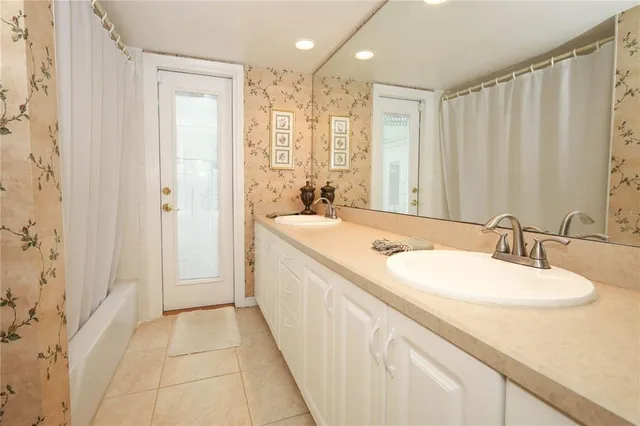 a bathroom with a double vanity sink and a mirror