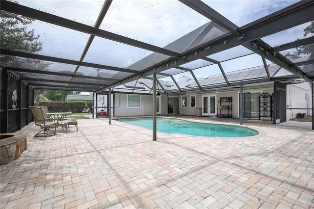 a view of a house with a backyard porch and sitting area