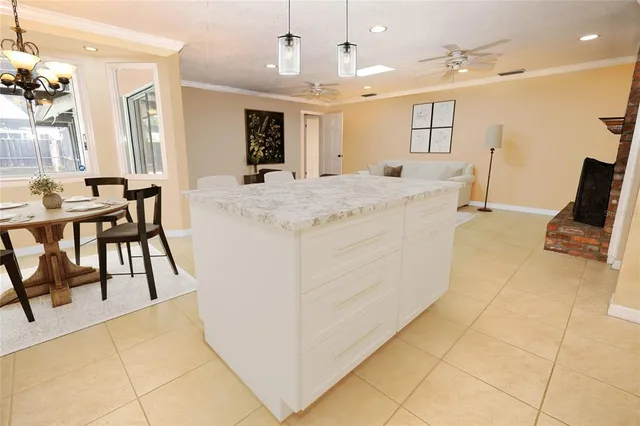 a large white kitchen with a large window