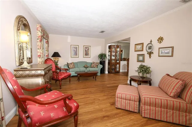 a living room with furniture fireplace and a large window