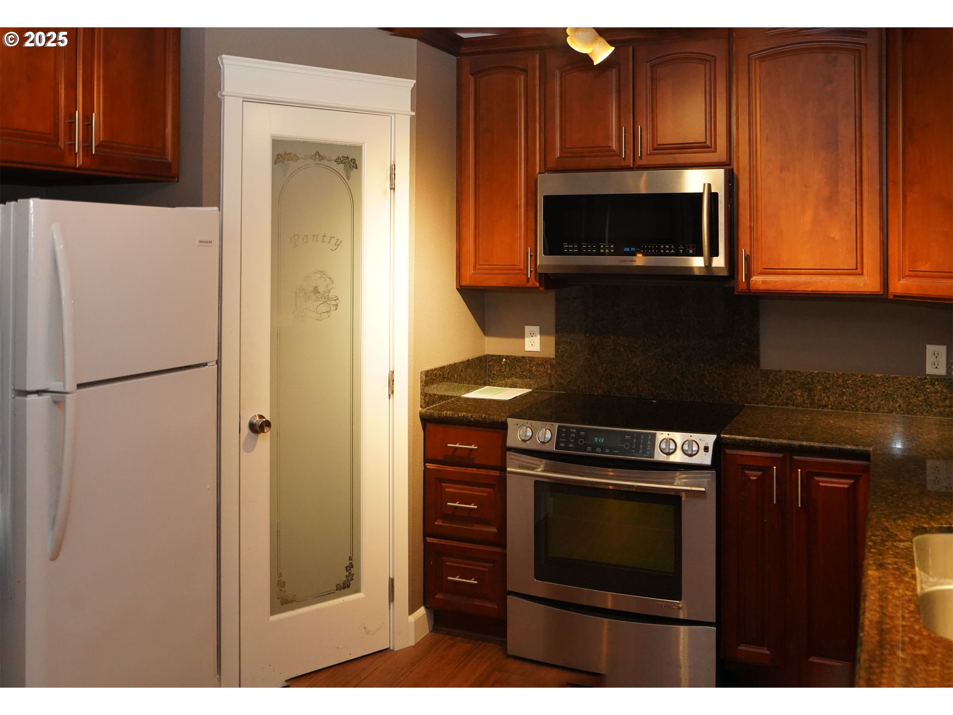 15411 Southeast Mill Plain Boulevard, Unit D3 Vancouver, WA 98684 - Photo 10 of 23 a kitchen with wooden cabinets and a stove top oven