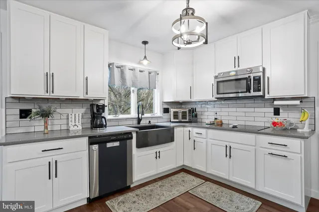 a kitchen with stainless steel appliances granite countertop a sink and cabinets