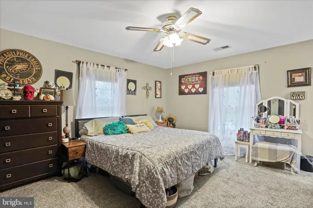 a bedroom with a bed and a baby bed