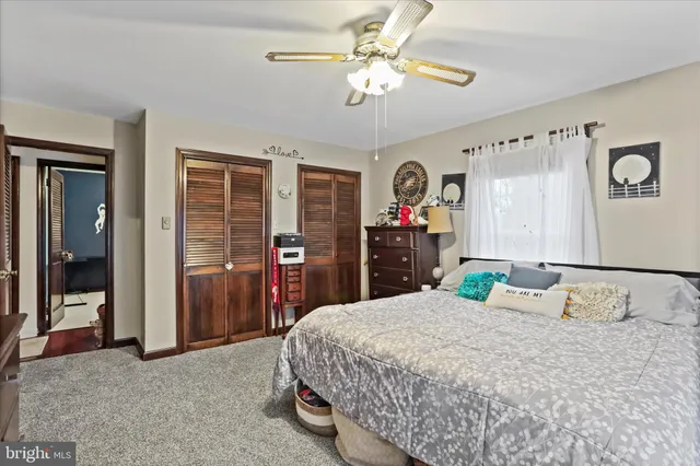 a bedroom with a bed dresser and a window