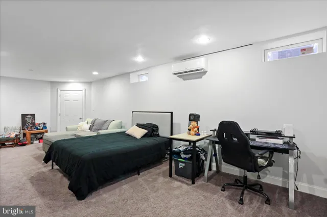 a bedroom with a bed a desk and chair