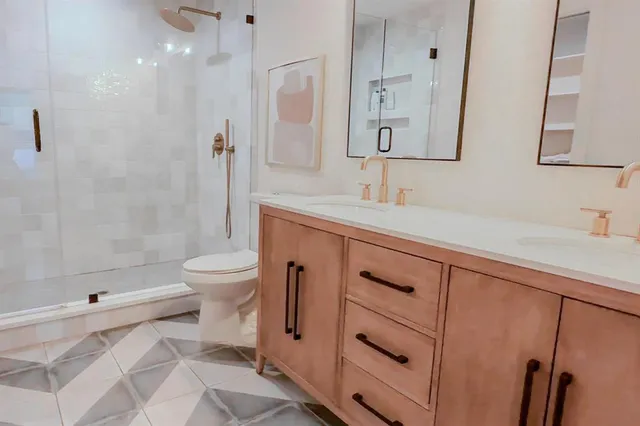 a bathroom with a sink a toilet and shower