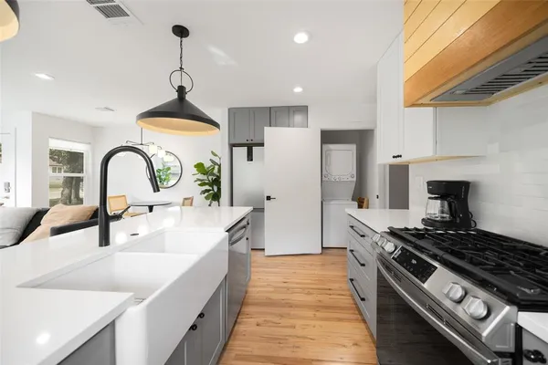 a kitchen with a sink stove and refrigerator