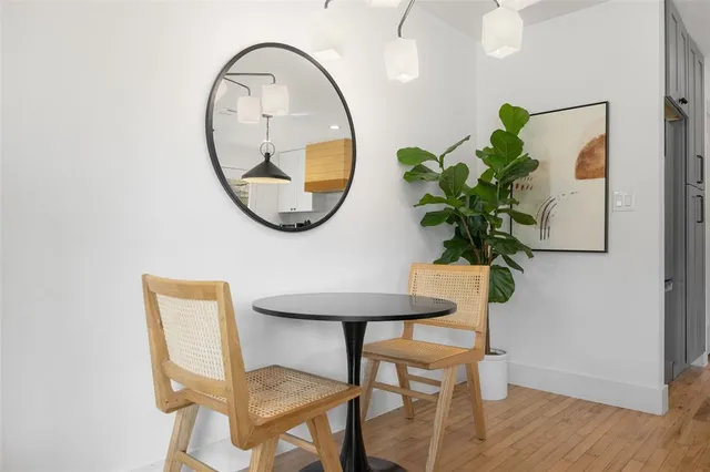 a view of a dining room with furniture and a potted plant