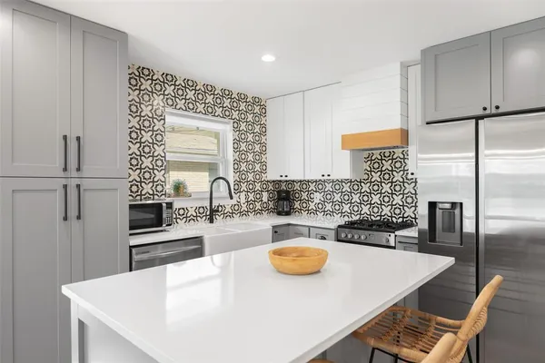 a kitchen with a table chairs and a refrigerator