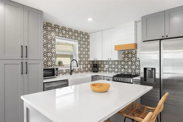 a kitchen with a table chairs and a refrigerator