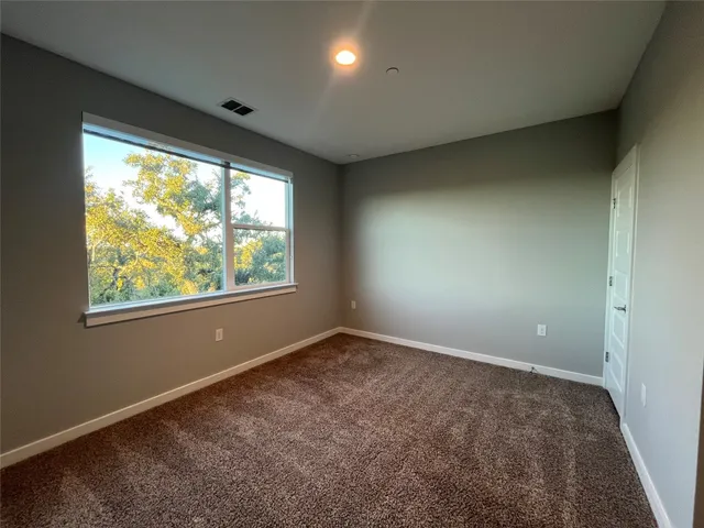 an empty room with large windows