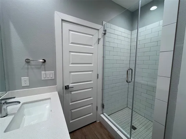 a bathroom with a shower and a sink