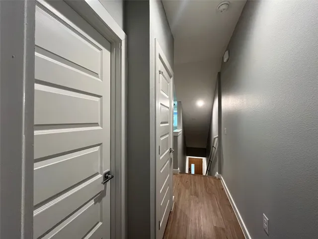 a view of a hallway view with wooden floor