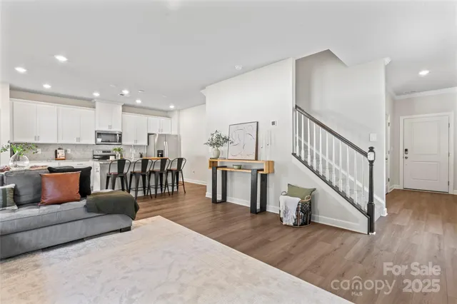 a living room with lots of furniture and kitchen view