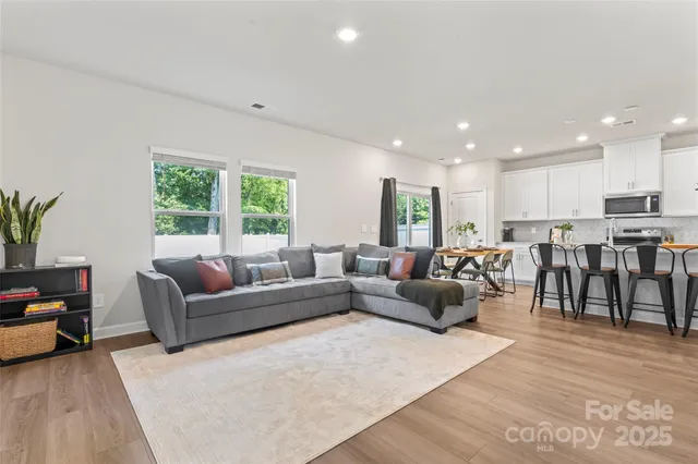 a living room with lots of furniture and a large window