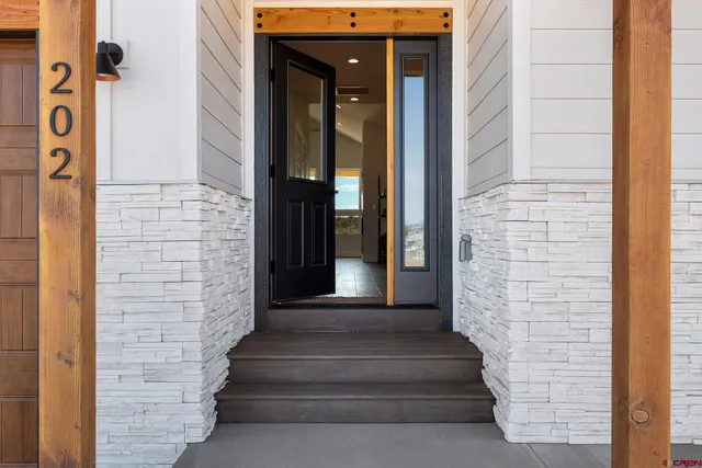 a hallway with a elevator and wooden floor
