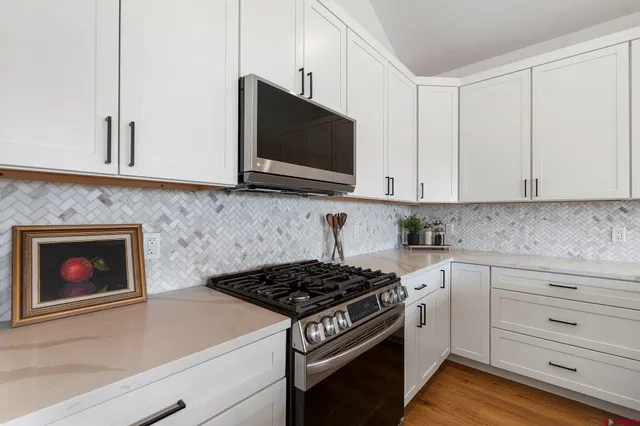 a view of a kitchen with a sink and cabinets