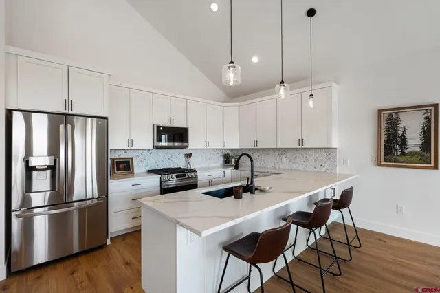 a view of living room with furniture and a wooden floor