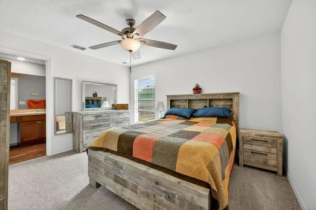 a bedroom with a bed and a chandelier