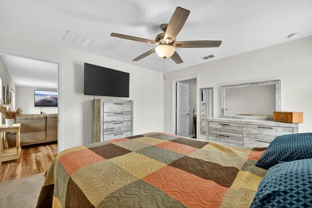 a bedroom with a bed and a flat screen tv