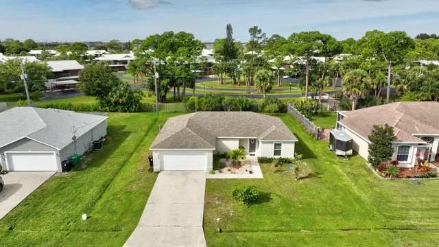 an aerial view of a house with yard swimming pool and outdoor seating