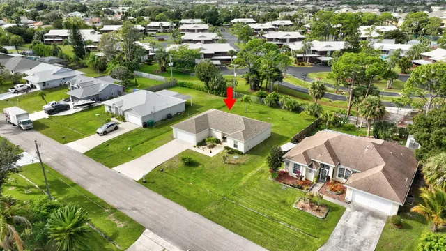 an aerial view of a house with outdoor space pool seating area and yard