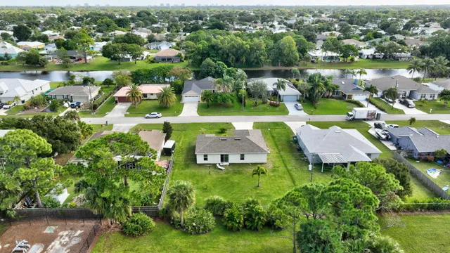 an aerial view of a houses with a lake view