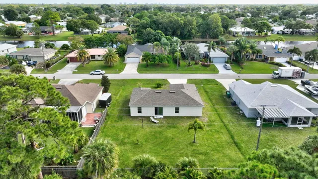 an aerial view of a house with swimming pool yard and outdoor seating
