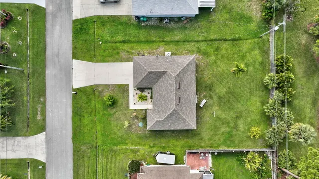 an aerial view of a house with a yard