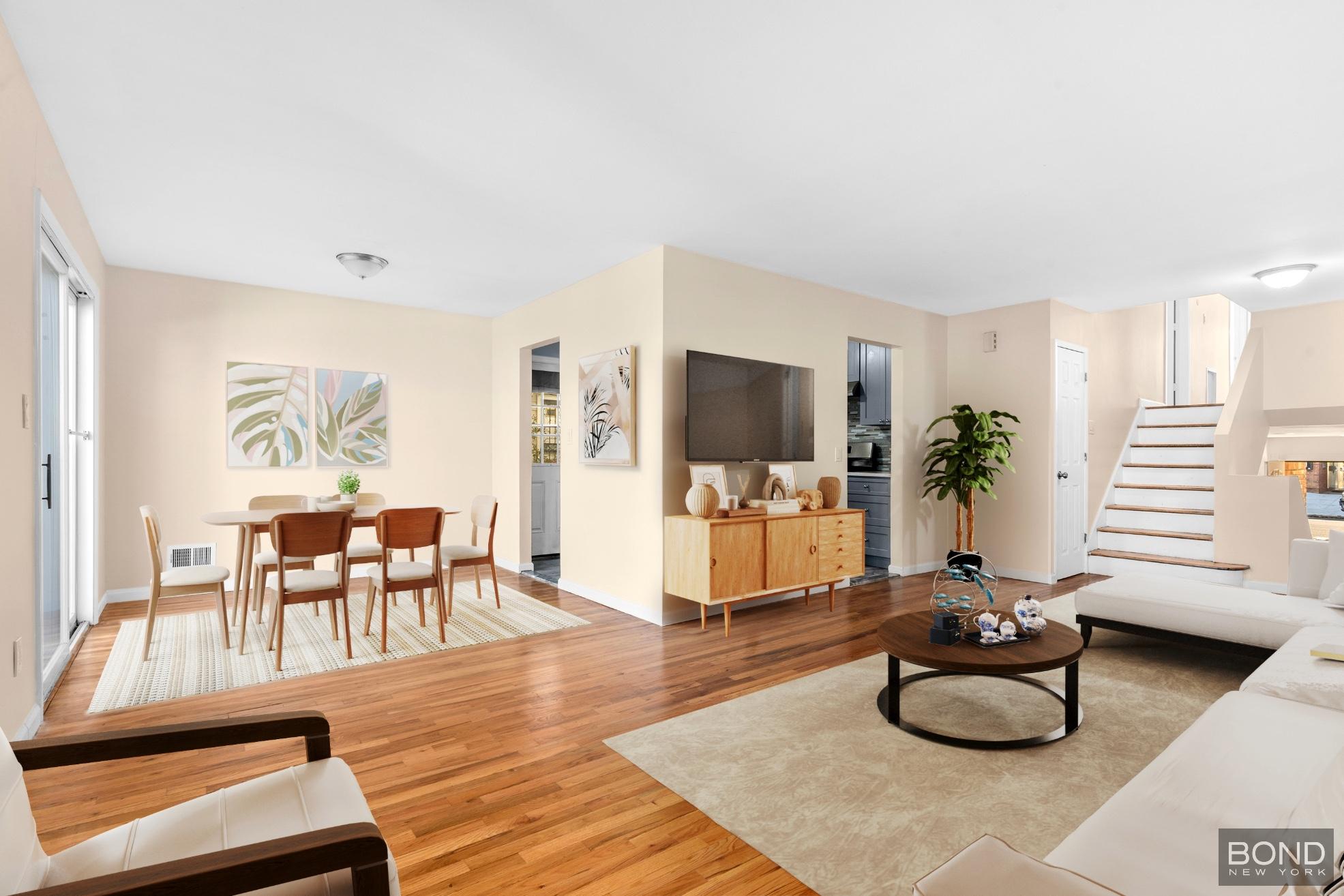 15-47 209th Street Queens, NY 11360 - Photo 3 of 11 a living room with furniture and a flat screen tv
