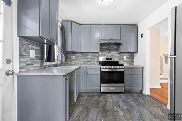 a kitchen with a stove and a refrigerator