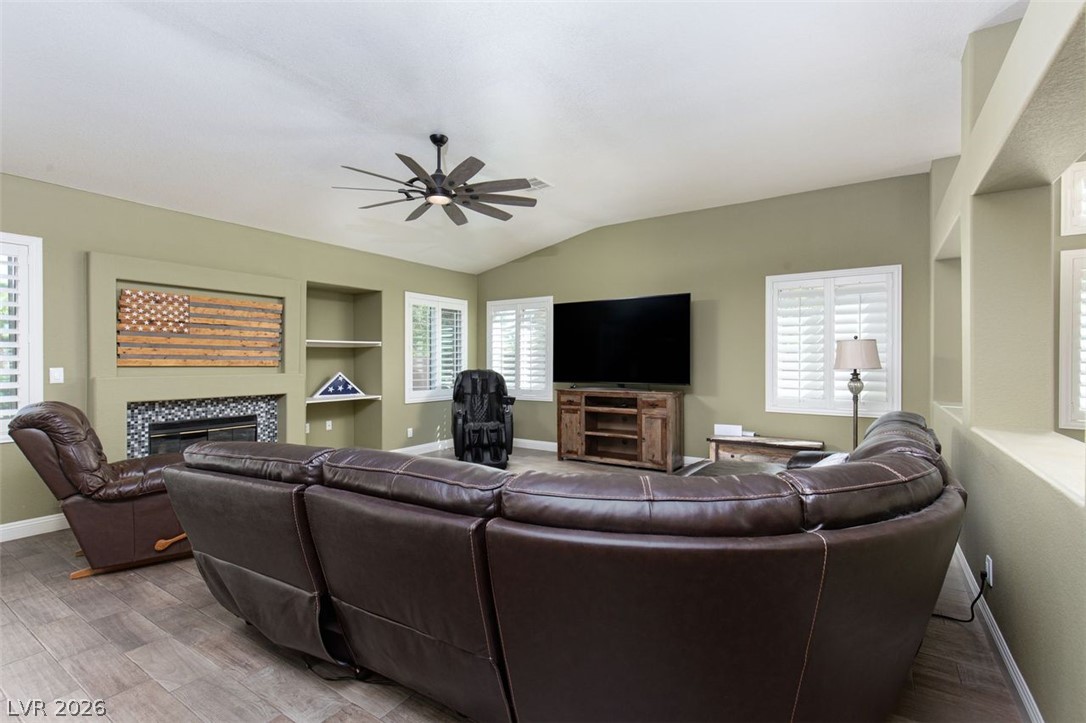 4670 Los Rancheros Avenue Las Vegas, NV 89129 - Photo 14 of 57 An inviting hearth centers the spacious living area highlighted by vaulted ceilings and tile flooring.