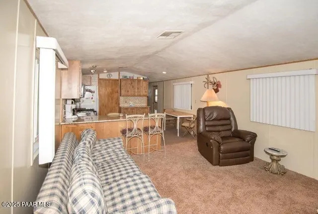 a bedroom with furniture and a large window