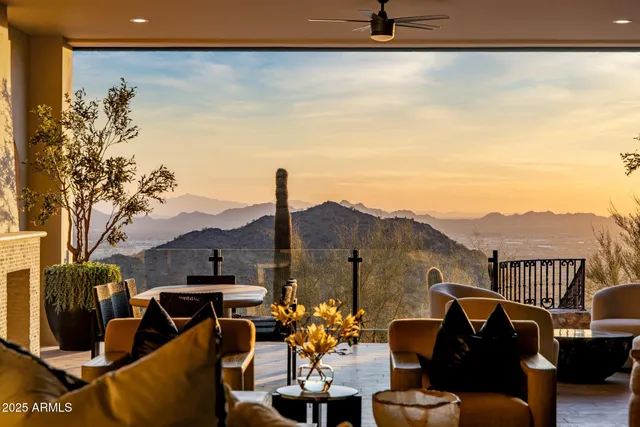 a balcony with table and chairs