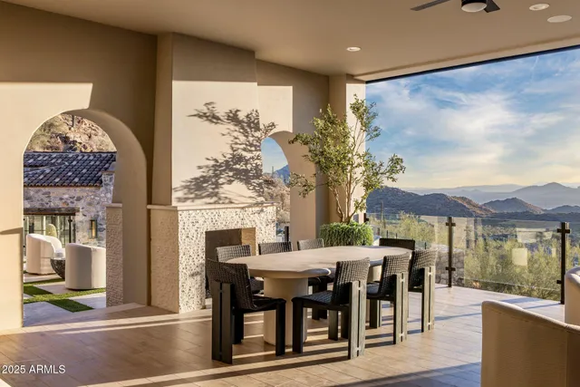 a living room with furniture a lamp and a large window