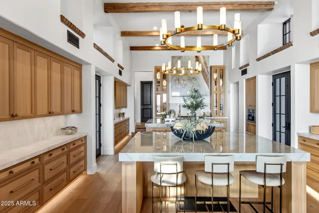 a kitchen with cabinets and chandelier