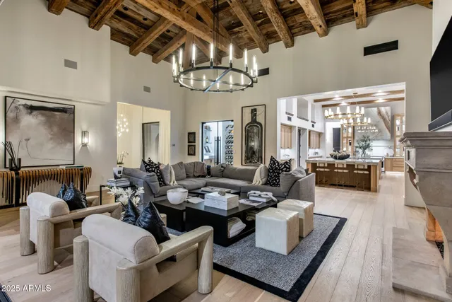 a living room with fireplace furniture and a floor to ceiling window