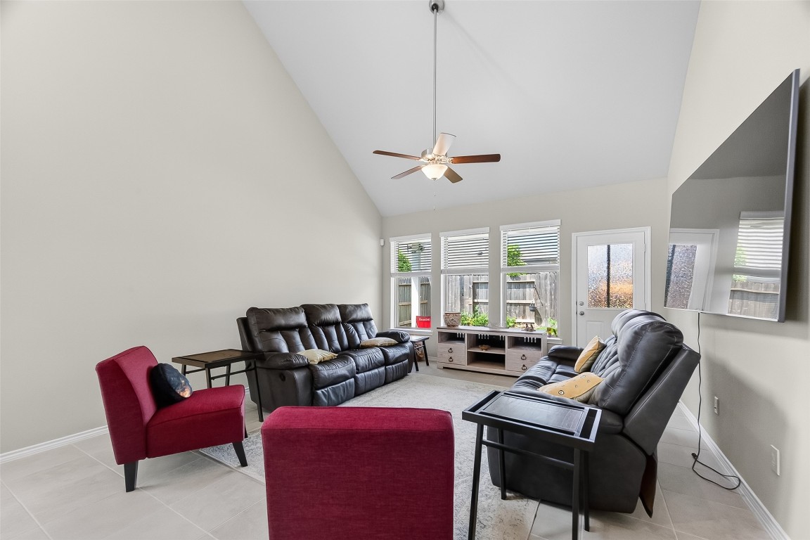 2739 Meadow View Lane Conroe, TX 77385 - Photo 12 of 50 a living room with furniture a ceiling fan and a window