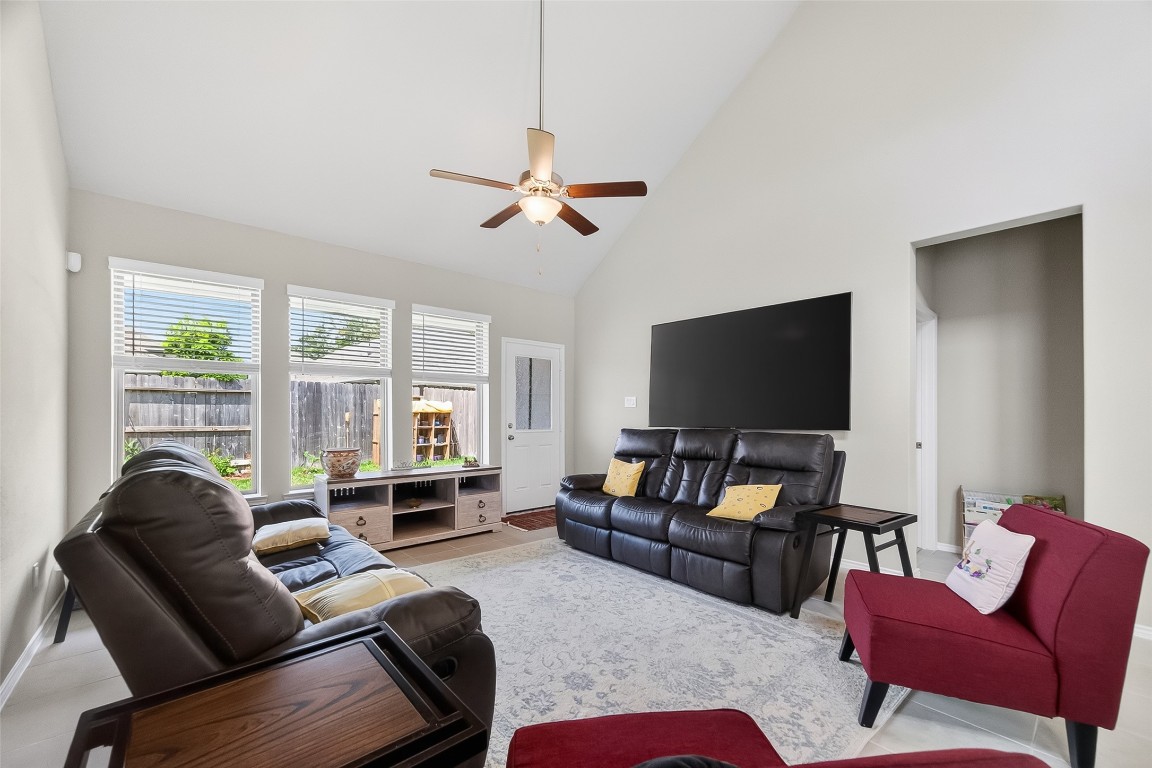 2739 Meadow View Lane Conroe, TX 77385 - Photo 13 of 50 a living room with furniture a large window and a flat screen tv