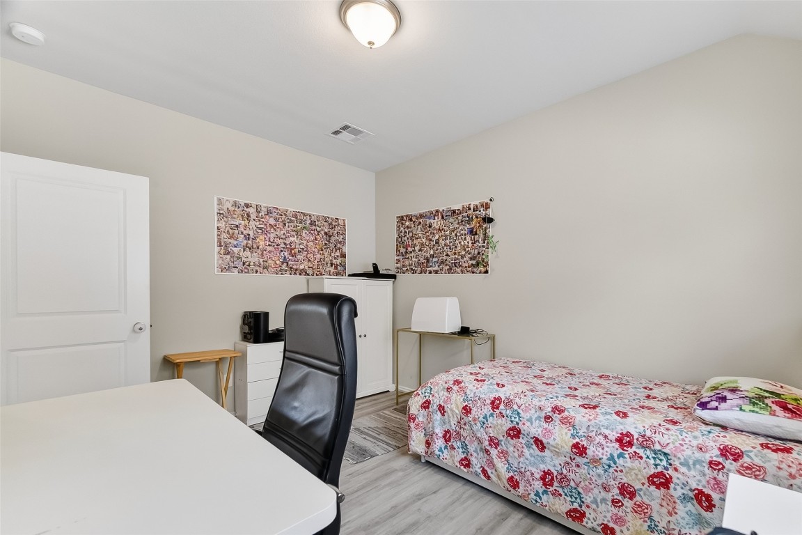 2739 Meadow View Lane Conroe, TX 77385 - Photo 26 of 50 a bedroom with a bed and a chair in it