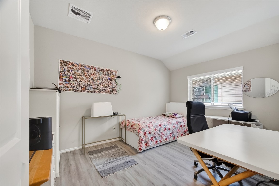 2739 Meadow View Lane Conroe, TX 77385 - Photo 27 of 50 a bedroom with two beds and a desk