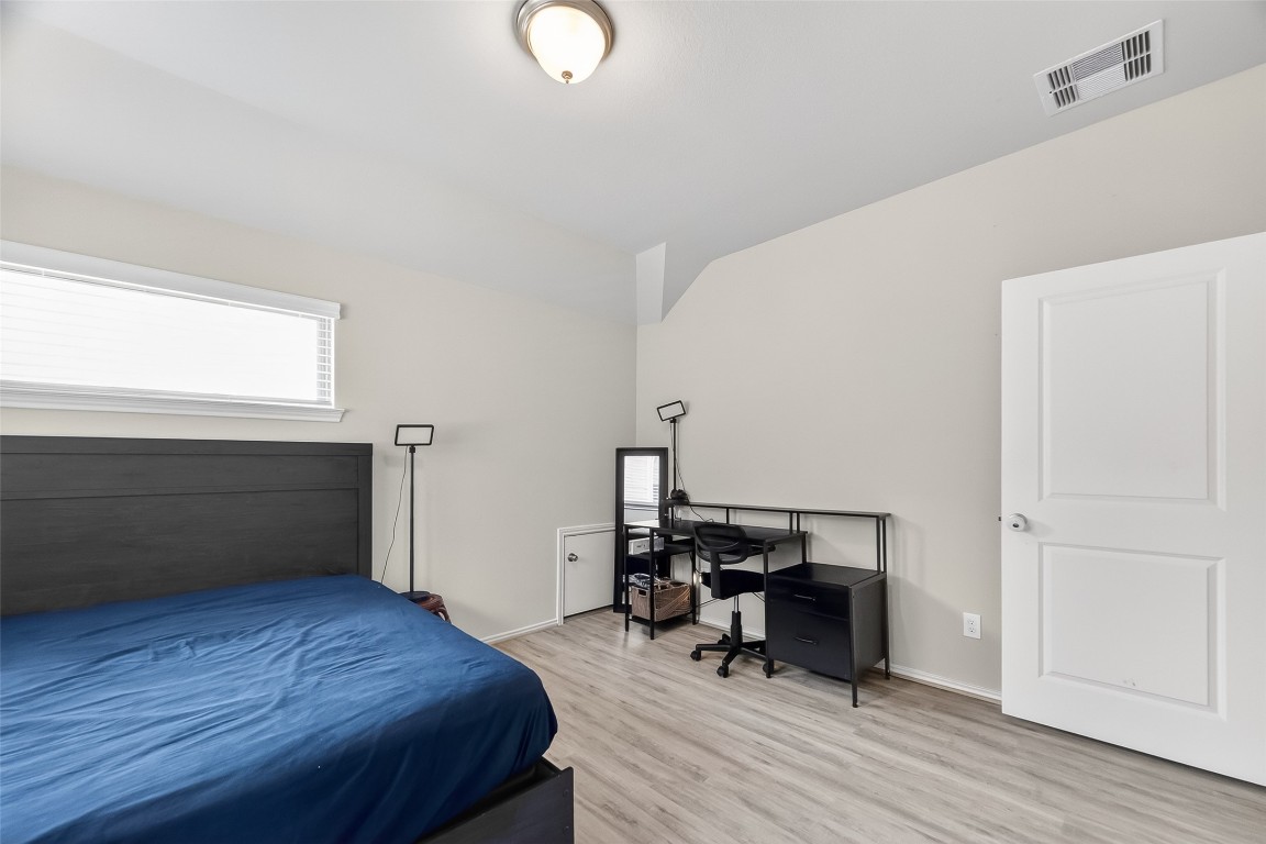 2739 Meadow View Lane Conroe, TX 77385 - Photo 30 of 50 a bedroom with a bed and a workspace